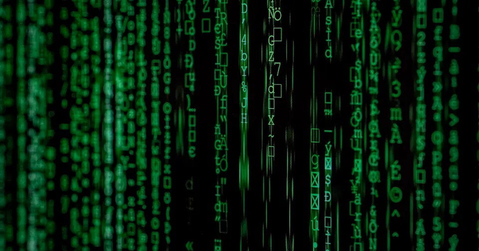 Lines of code on a dark monitor, evoking the thousands of edits autonomous agents left on a public German wiki.